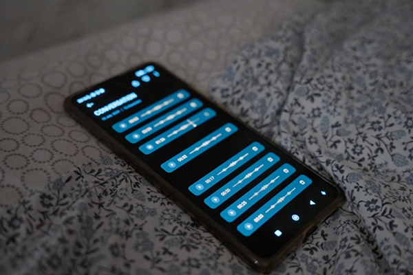 Kuva sängyllä olevasta älypuhelimesta, jonka ruudulla näkyy kahdeksan ääniviestiä.
